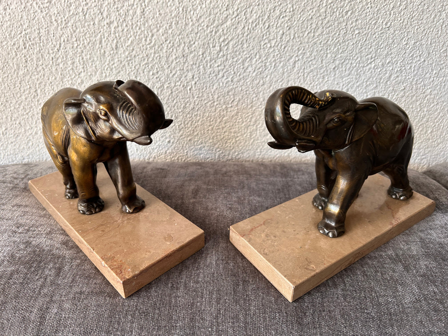 French Art Deco Bronze Elephant Bookends — Matched Pair, Trunks Raised, on Travertine Bases